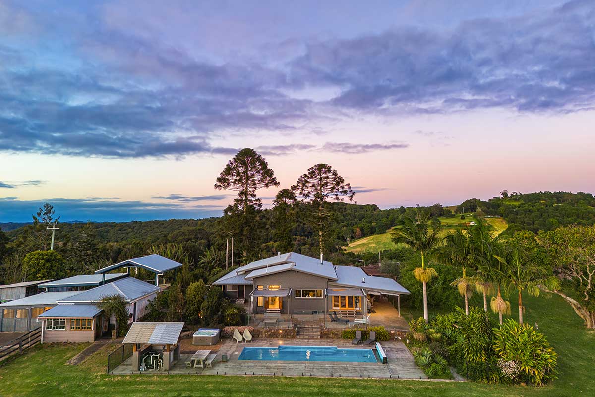 Cromwell Farm House with pool, pine trees, palm trees and a pastel sunset